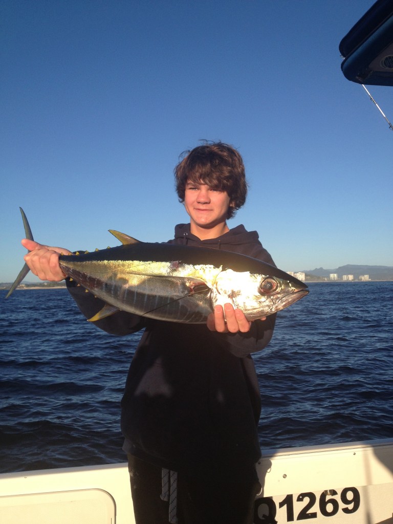 This young lad caught the tuna. We later beat him up in the car park and stole half of it!