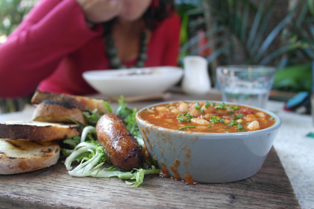 Home "Town" bake dbeans on sourdough toast with Hayters Hill pork and black pepper sausage $15.50