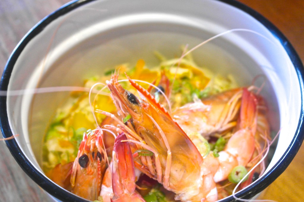 Put the prawns and sauce in there too