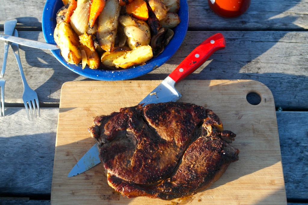 Liberally sprinkled with camp seasoning and served with roast potato, pumpkin, carrot and onion all cooked in the coals… we are not heathens 