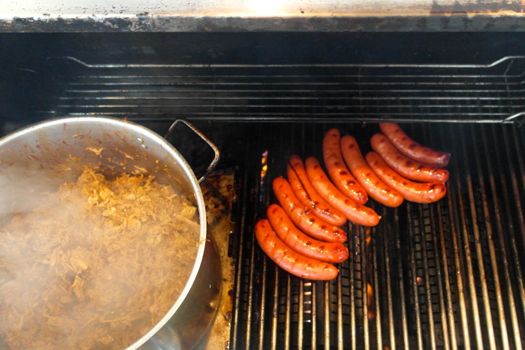 Cook some sausages on the BBQ and while your at it, get a nice pot of pulled pork on there too