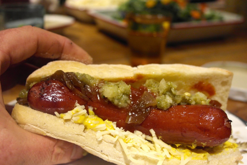 Smoked sausage, sauerkraut, caramelised onion, mustard, tomato relish, jalapeño relish and gruyere cheese, in a roll and about to make it's way into my belly