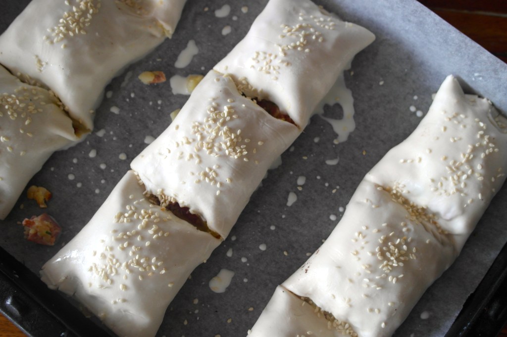 Cut into two or three sections per roll, egg wash and hit them with sesame seeds