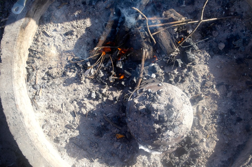 The cake in it's new home amongst the coals
