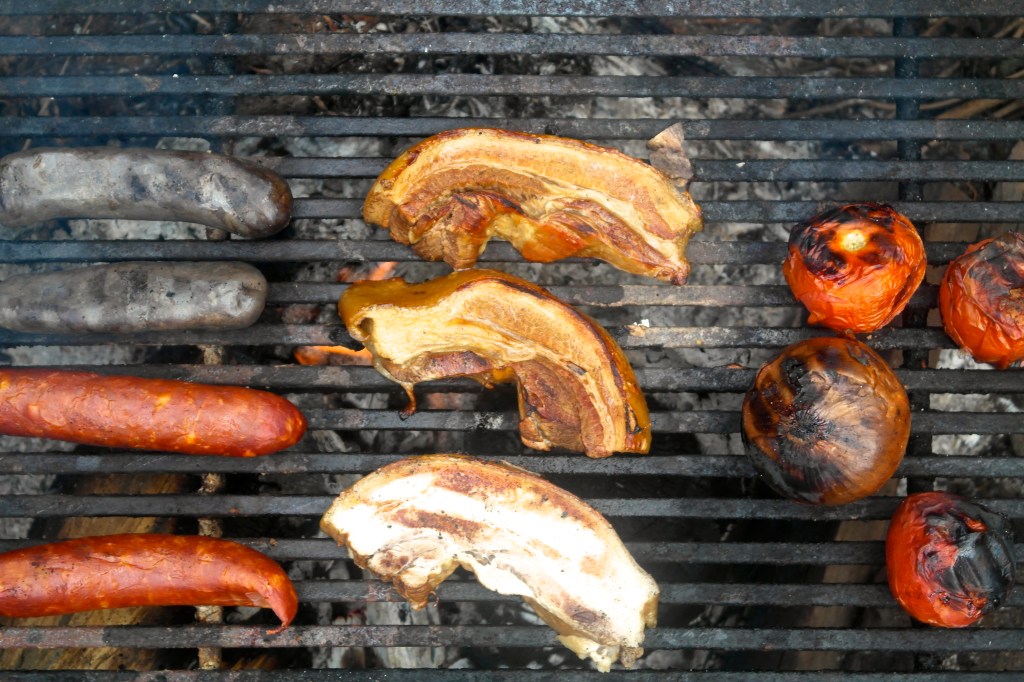 This is called fore-play around here. Pork belly, morcilla and chorizo, and tomato and onion charring up for the salsa