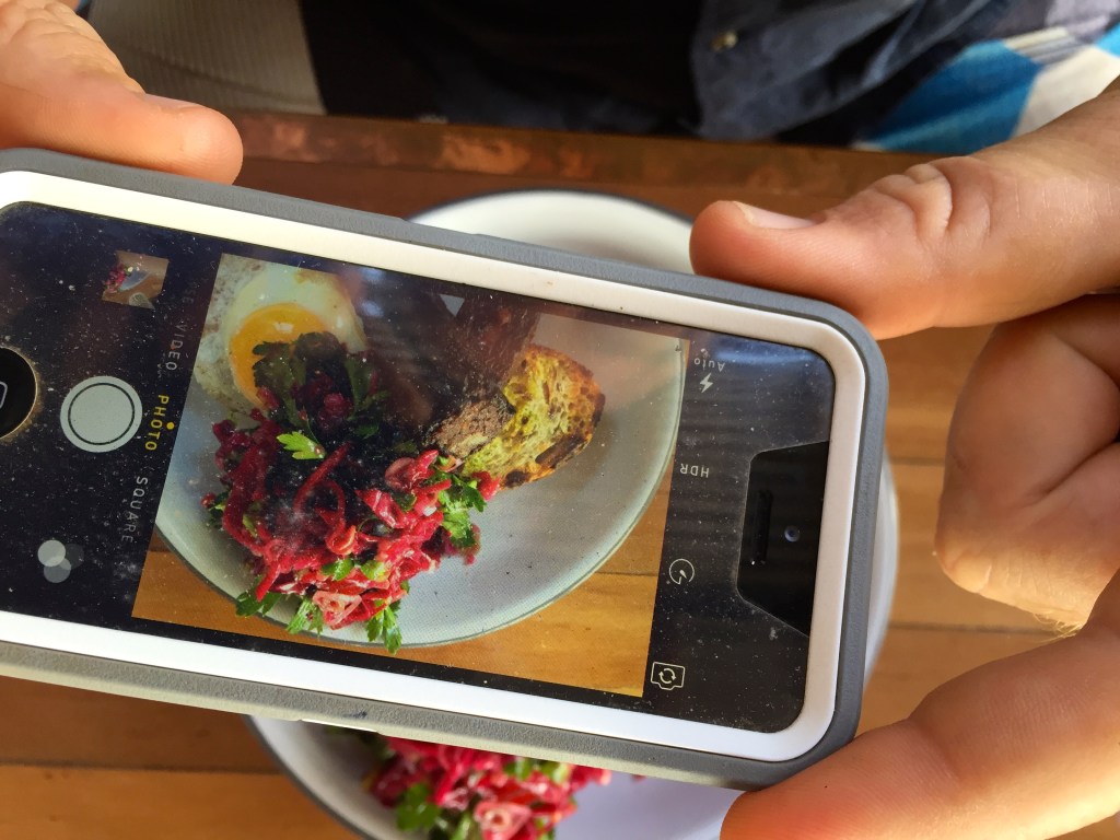 The blood cake with apples, beets, lemon, herbs, fermented cabbage salad, fried egg and toast ($23)