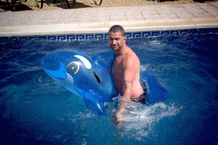 Is that a dolphin between your legs or are you just happy to be on holiday?