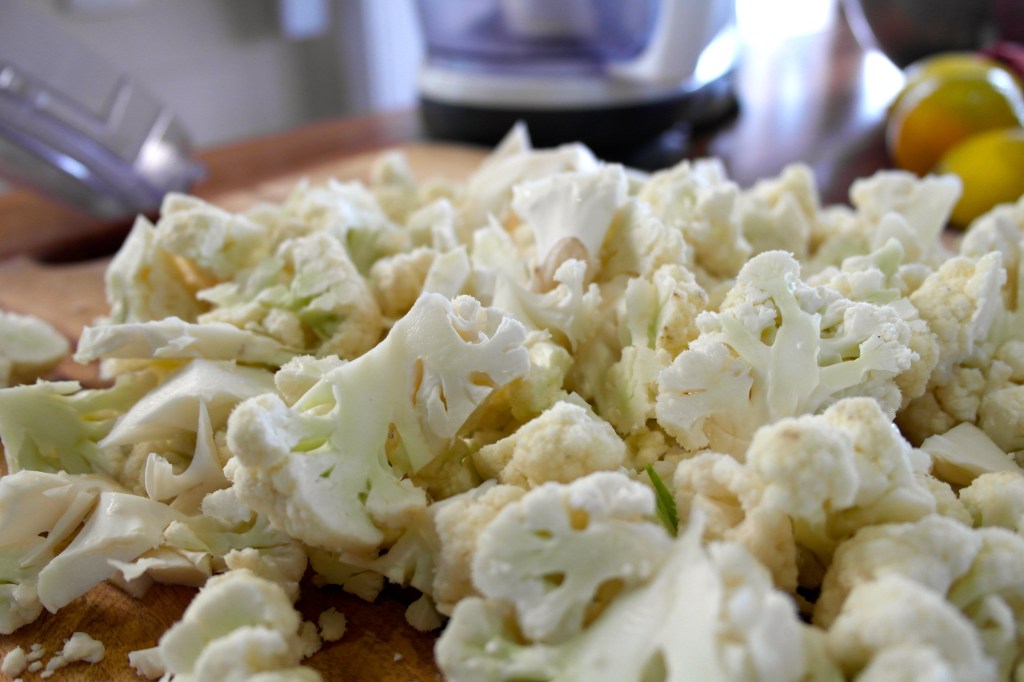 The cauliflower cut into florets right before I cous the heck out of it